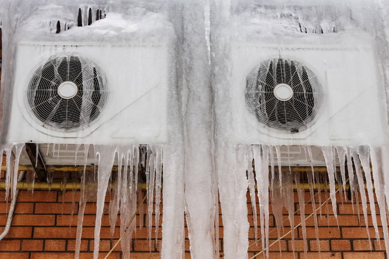 Outdoor air conditioning unit with ice built up on it.