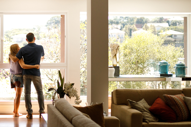 man & woman standing in front of a window on a hot day.